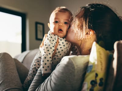 Resident kissing her baby at home at Amador Apartments in Hayward, California