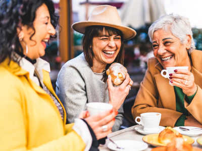 Happy friends having coffee near The Blakely in Shoreline, Washington