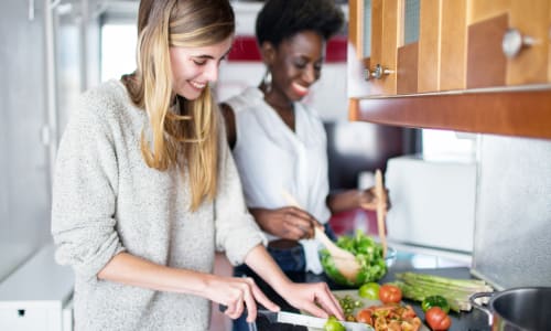 Friends cooking a meal at Chelsea in Raleigh, North Carolina