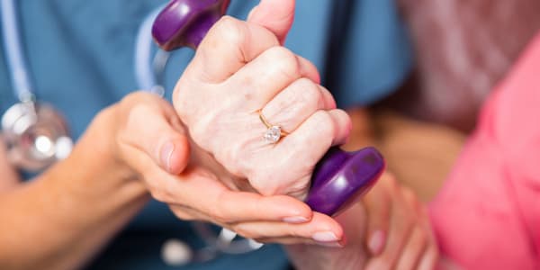 Resident lifting hand weights at Maple Ridge Care Center in Spooner, Wisconsin