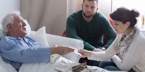 resident looking at photos with family members at Edgerton Care Center in Edgerton, Wisconsin