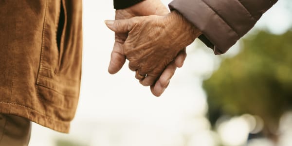 Residents holding hands walking outside at Transitions At Home - West in Mount Horeb, Wisconsin