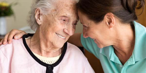 Mobility-challenged resident being assisted by a caretaker at Retirement Ranch in Clovis, New Mexico