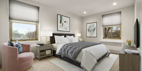 Large master bedroom with plush carpeting at Camelot Court in Brighton, Massachusetts