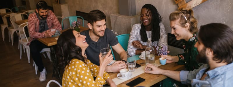 Group of friends having drinks and catching up with each other at a cool bar near Eastgold NYC in New York, New York