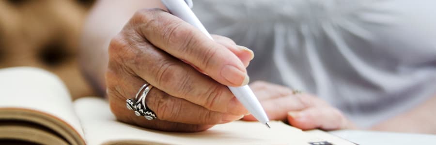 Resident signing papers at a WISH community