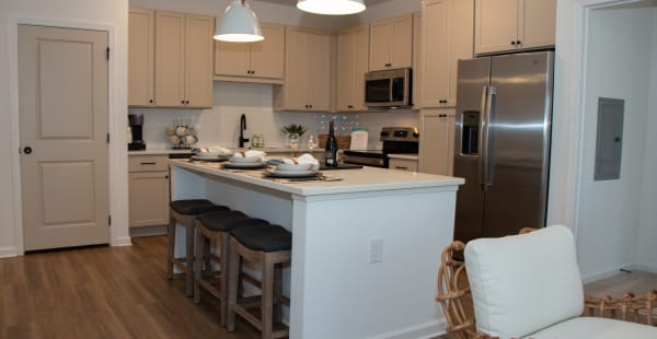 Luxury kitchen with a large island and pendant lighting at Primrose at Santa Rosa Beach in Santa Rosa Beach, Florida