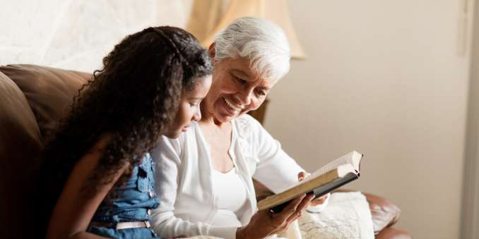 Resident reading with a younger family member at The Barclay in Charlottesville, Virginia