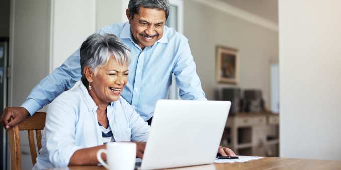 Resident couple using a laptop at River's Edge by Barclay House in Savannah, Georgia