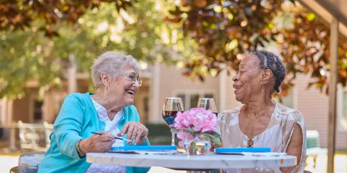 Resident and caretaker laughing at Barclay House of Augusta in Augusta, Georgia