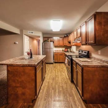 Kitchen with wood-style flooring at Brookwood Apartments in Indianapolis, Indiana