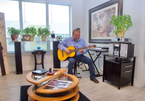 Resident playing guitar at The Jordan at Mueller in Austin, Texas