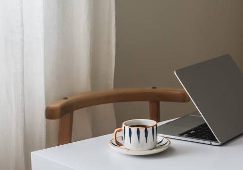 Sitting area with laptop and cup of coffee