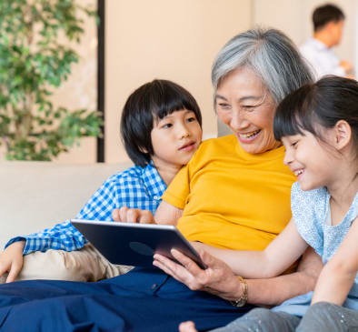 Asian senior woman on tablet with grandchildren in Seattle, WA
