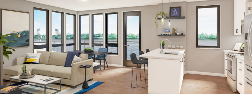 Interior rendering of a kitchen and living room with view of the river at The Columbia at the Waterfront in Vancouver, Washington