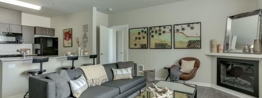 Living Room and Kitchen with Fireplace in an apartment at pet-friendly Terrene at the Grove in Wilsonville, Oregon