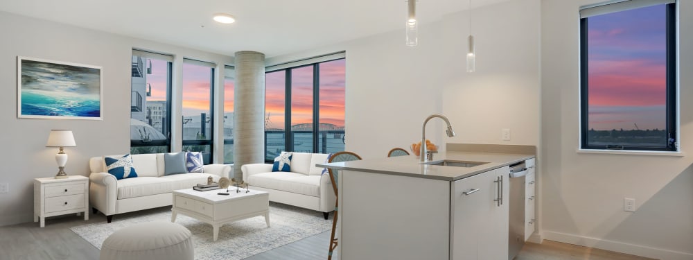 Interior of a kitchen and living room with view of the river at The Columbia at the Waterfront in Vancouver, Washington