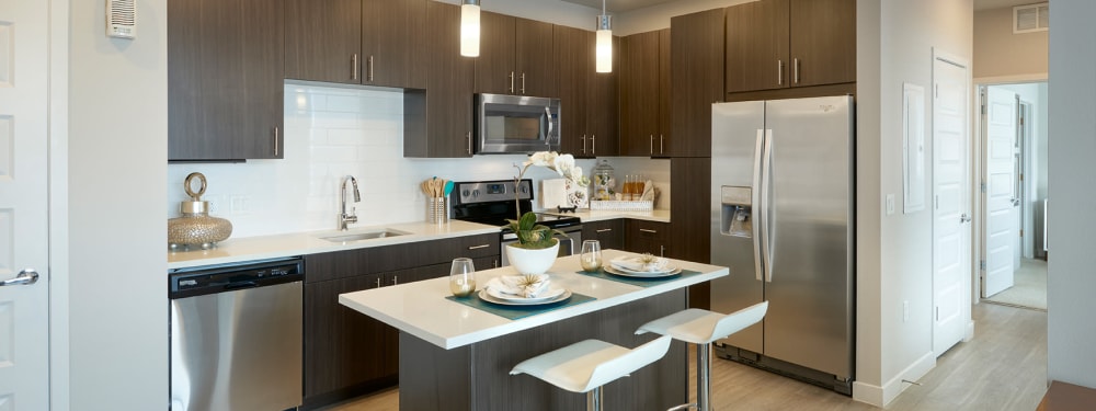 A kitchen with modern, tan cabinetry at Strata Apartments in Denver, Colorado
