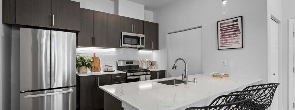 Open Kitchen with Brown Cabinets at The Highlands at Silverdale in Silverdale, Washington