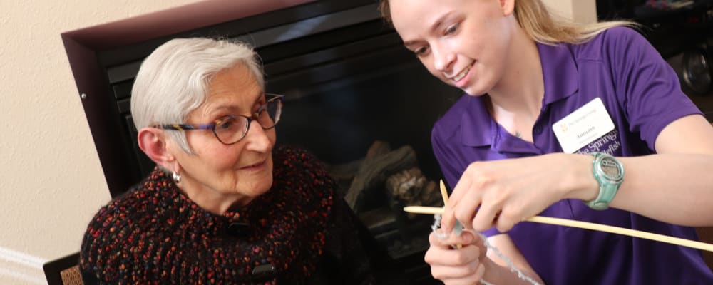 Resident and caregiver knitting at The Springs at Whitefish in Whitefish, Montana