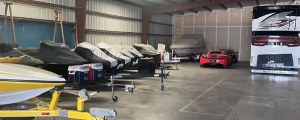 Indoor boat and car storage at a BlueGate Boat & RV Storage location