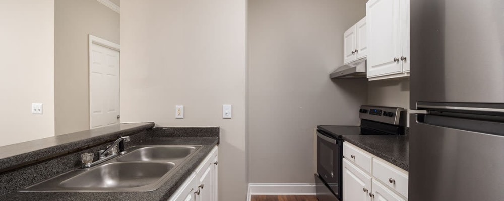 Black countertops and appliances in an apartment kichen at Brighton Park in Byron, Georgia