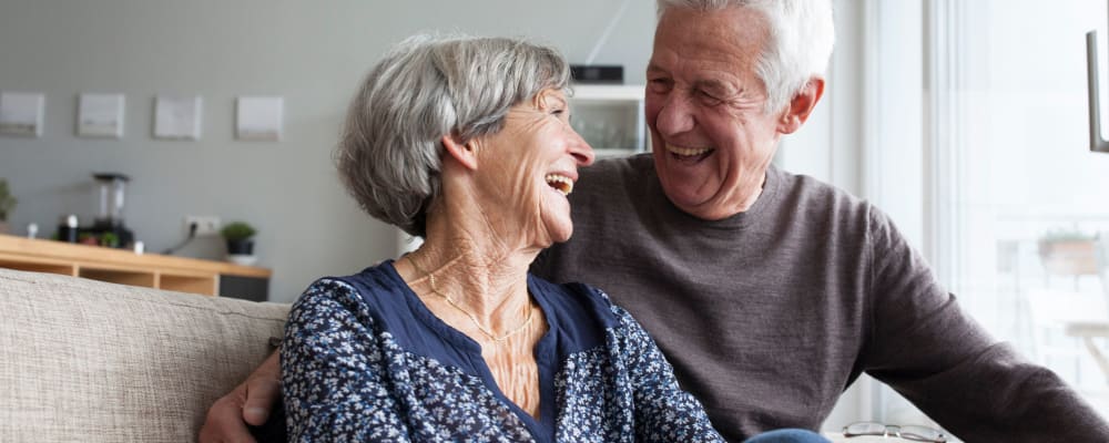 A man and woman walking together at The Peaks at South Jordan Memory Care in South Jordan, Utah