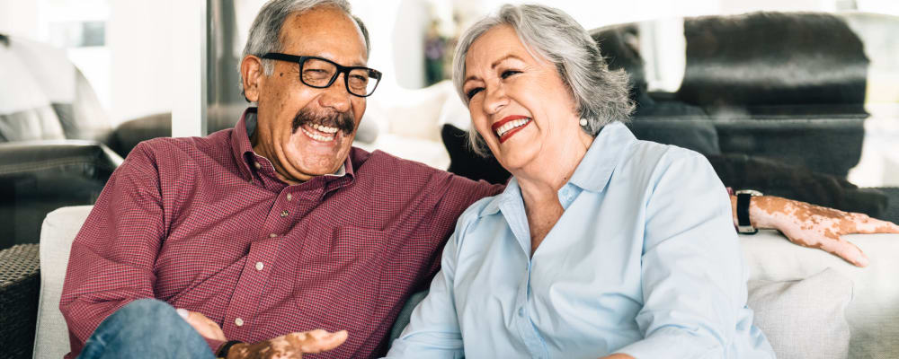 A resident smiling at a staff member at The Peaks at South Jordan Memory Care in South Jordan, Utah