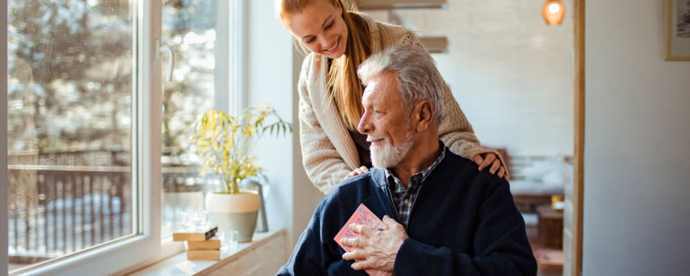 A staff member talking to a resident at The Ridge at Lansing in Lansing, Michigan