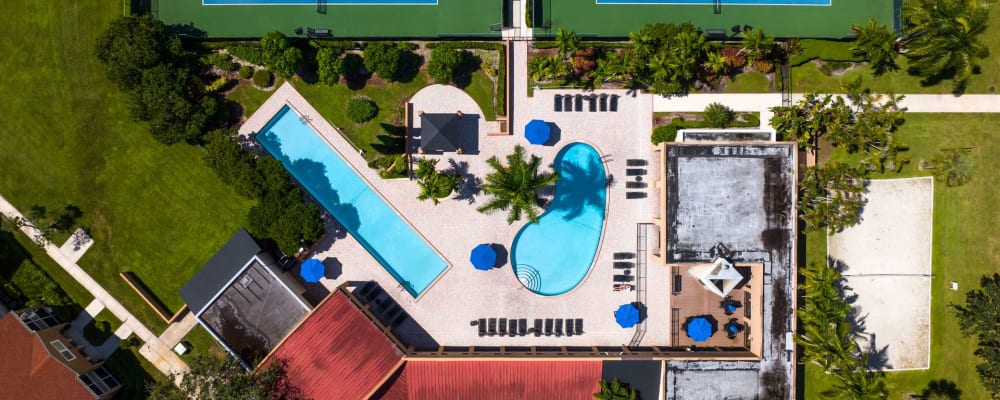 Aerial view of the community swimming pools and leasing office at Azalea Village in West Palm Beach, Florida