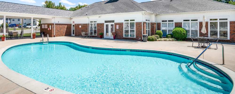 Swimming pool with lounge seating at Cloisters of Concord in Concord, North Carolina