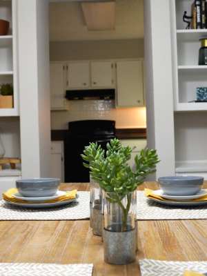 Dining table with setting for two at The Abbey at Regent's Walk in Homewood, Alabama