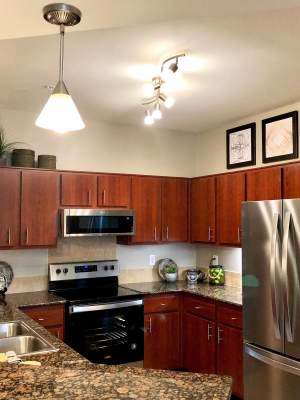 Modern kitchen with hanging light at The Abbey on Lake Wyndemere in The Woodlands, Texas