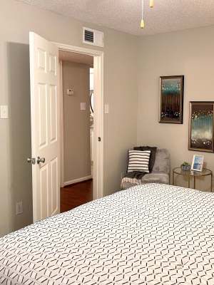 Bright bedroom with large bed at The Abbey at Briargrove Park in Houston, Texas