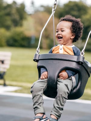 Resident kid playing on swing at Mariner's Pointe in Joppatowne, Maryland