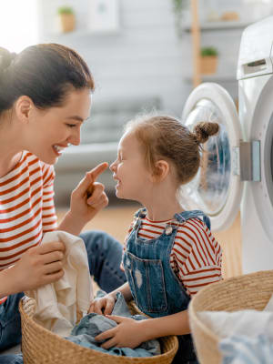Resident and their daughter using the laundry facility at Reserves at Tidewater in Norfolk, Virginia