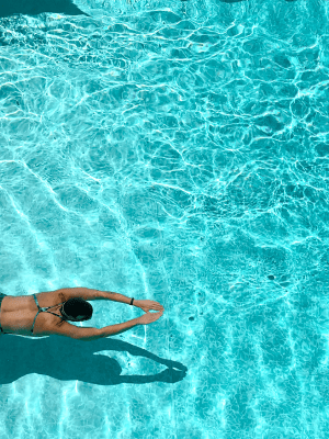 Resident swimming in the pool at The Abbey at Grande Oaks in San Antonio, Texas