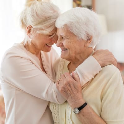 Woman hugging elderly mother
