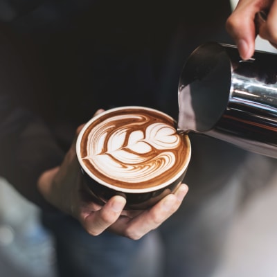 Barista making an artful latté near Sofi Canyon Hills in San Diego, California