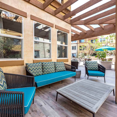 Luxurious outdoor lounge with a pergola overhead at Sofi at Topanga Canyon in Chatsworth, California