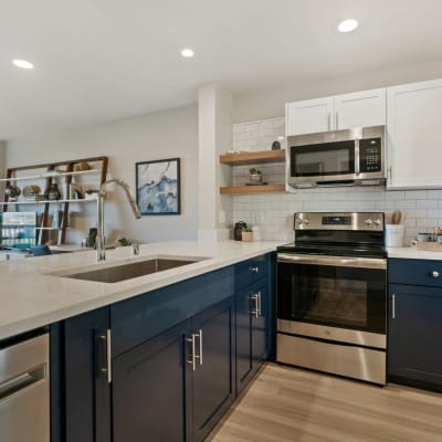 Well-decorated kitchen with stainless steel appliances in a model home at Harbor Point Apartments in Mill Valley, California