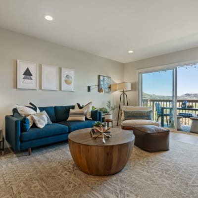 Spacious living room with patio with bay views in a model home at Harbor Point Apartments in Mill Valley, California