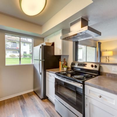 Renovated kitchen with stainless steel appliances at Sofi Ventura in Ventura, California