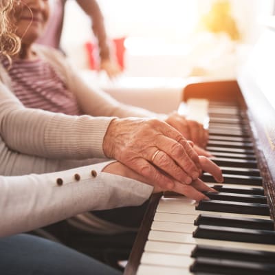 Resident giving a piano lesson at Westminster Memory Care in Aiken, South Carolina