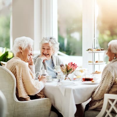 Residents sitting in a sunlit cafe eating breakfast at Deephaven Woods in Deephaven, Minnesota