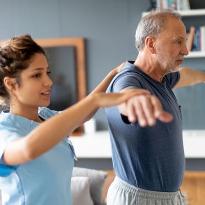 Resident working with a physical trainer at Deephaven Woods in Deephaven, Minnesota