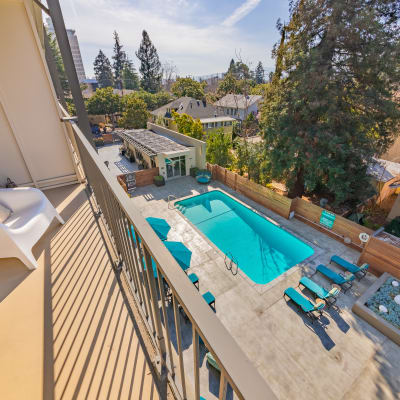 View of the pool from outdoor unit balcony in a model home near Mia in Palo Alto, California