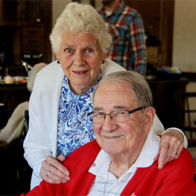 Resident couple smiling at the camera at Deephaven Woods in Deephaven, Minnesota