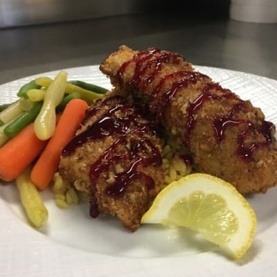 Pecan encrusted walleye with rice and vegetables available at First & Main of Bloomfield Township in Bloomfield Township, Michigan