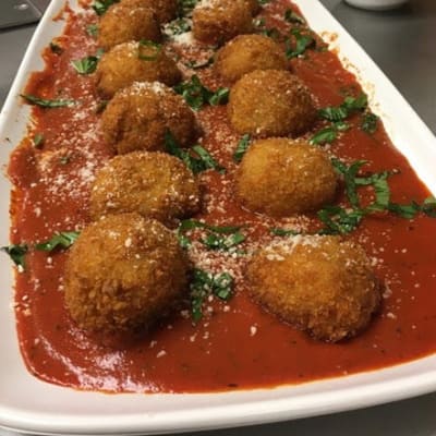 Stuffed Risotto balls with gruyere cheese and marinara sauce served at First & Main of Lewis Center in Lewis Center, Ohio